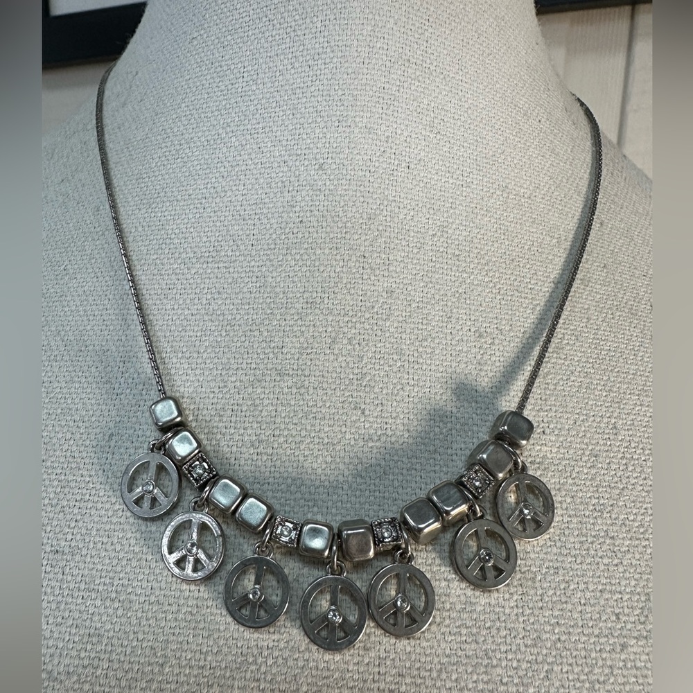 Silvertone multi peace sign charm style dangle necklace